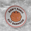 Beautiful "Don't Panic Eat Panic" Sticker made with waterproof holographic sticker paper—art created by Faith Trottier.